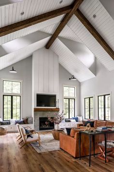 a living room filled with furniture and a fire place in the middle of a room