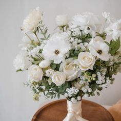 a bouquet of white flowers is sitting on a table