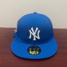 a new york yankees hat sitting on top of a wooden table