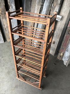 an old wooden rack sitting on top of a cement floor