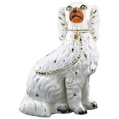 a white dog statue with chains on it's collar and eyes closed, sitting in front of a white background