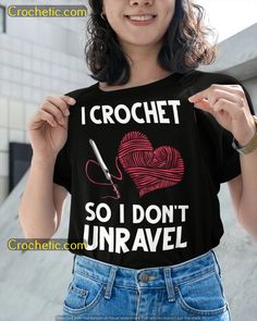 a woman holding up a t - shirt that says crochet so i don't unravel