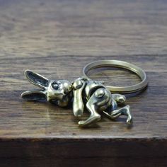 "Movable Rabbit keyring.  The Left chest is marked with \"Ω\". This keyring is made in Japan. material⇒Brass 44㎜×14㎜ (1.73in×0.55in) 17g" Weird Jewelry, Cute Keychains, Van Helsing, Rabbit Lover, Animal Care, Cool Items, Conversation Piece, Made In Japan, Keychains