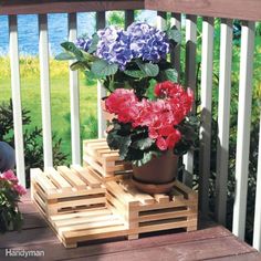 a potted plant sitting on top of two wooden pallets with flowers in them