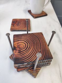 wooden coasters with metal handles on a table