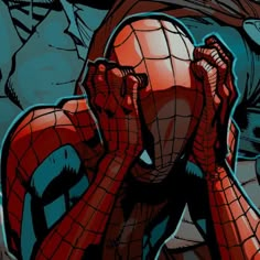 the spider - man is covering his face with his hands