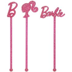 three pink cake toppers with the word barbie on them