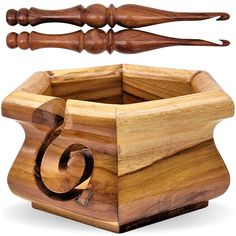 a wooden box with a handle and two spoons in it on a white background