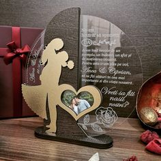 a personalized glass plaque with an image of a man and woman holding a heart