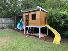 a child's play area in the backyard with a slide and climbing frame for children