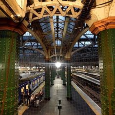 an overhead view of a train station with trains on the tracks