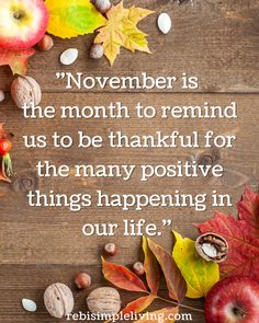 an apple, leaves and acorns on a wooden surface with the quote november is the month to remind us to be grateful for the many positive things happening in our life