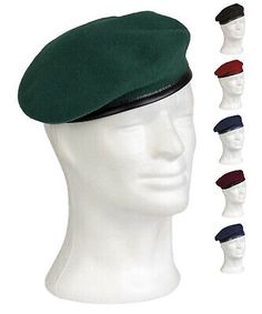 a white mannequin head wearing a green beret and five different colors of hats