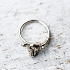 Sterling silver ring with a tiny cow head. Handmade in sterling silver with an adjustable ring band. Fits all sizes. If you want me to adjust it for you let me know your size when ordering. I make this ring on demand and it takes me up to 7 workdays to complete one. Other cow stuff: https://www.etsy.com/se-en/shop/AnnaSiivonen?search_query=cow Cow Ring, Cow Stuff, Cow Head, Band Fits, Septum Jewelry, You Want Me, Ring Band, Adjustable Ring, Solitaire Ring