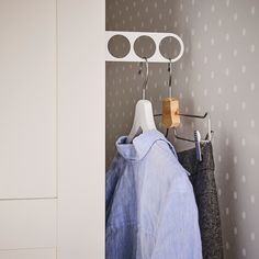 a coat rack with clothes hanging on it