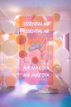 balloons are hanging from the ceiling in front of an advertisement for air maxxidia