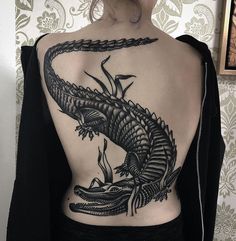 a woman with a tattoo on her back