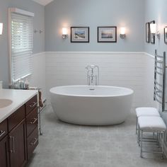 a large white bath tub sitting in a bathroom