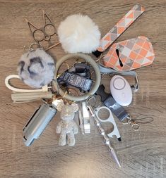 a bunch of items that are on top of a wooden table with scissors and other things