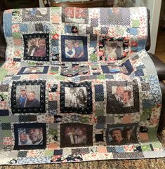 a quilted blanket with pictures of people and dogs on it in front of a chair