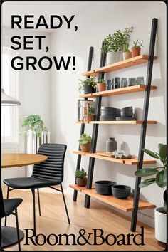 a dining room table and chairs with plants on the shelves