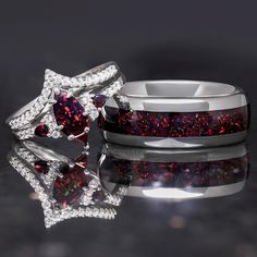 two wedding rings with red and white diamonds