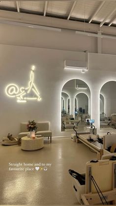 the interior of a hair salon with chairs and mirrors on the wall, lights in the background