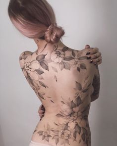 a woman with tattoos on her back