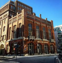 an old brick building on the corner of a street