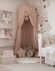 a baby's room is decorated in pink and white