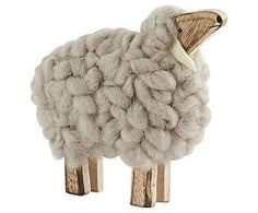 a sheep made out of wood sticks on a white background