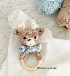 a crocheted teddy bear with a bow tie on it's ring