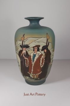 a vase with three people painted on it