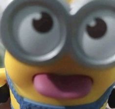 a close up of a minion holding a cell phone in front of the camera