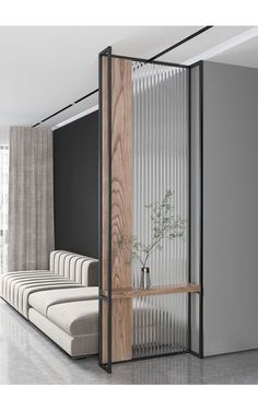 an open room divider in the middle of a living room with white and black walls