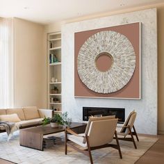 a living room filled with furniture and a large painting hanging on the wall over a fire place