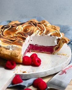 a raspberry pie with a slice missing from it