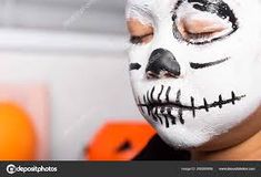 a person with white face paint on their face