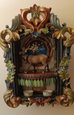 an ornately decorated wall shelf with a deer on it