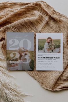 the wedding announcement card is displayed on top of a blanket with a furnishing