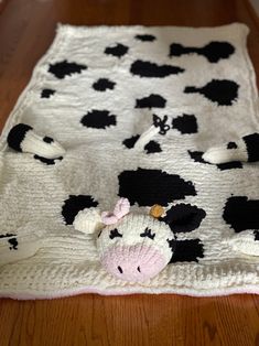 a black and white blanket with a cow on it