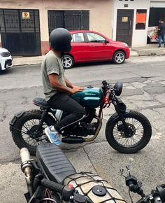 a man riding on the back of a motorcycle down a street