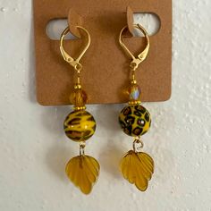 New Handmade Earrings, Hangs 2”. Acrylic Cheetah Print Bead, Sea Glass Like Leaf, Yellow Faceted Glass Bead With Aurora Borealis Coating And Gold Tone Spacers On A Hypoallergenic Gold Tone Stainless Steel Lever Back Hooks. Fun Design! Yellow Beaded Earrings With Czech Glass, Yellow Beaded Czech Glass Earrings, Yellow Beaded Earrings In Czech Glass, Nickel Free Yellow Czech Glass Earrings, Nickel-free Yellow Czech Glass Earrings, Nickel-free Yellow Beaded Earrings As Gift, Nickel Free Yellow Beaded Earrings For Gift, Nickel-free Yellow Beaded Earrings For Gifts, Yellow Czech Glass Beaded Dangle Earrings