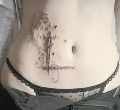 a woman with a tattoo on her stomach