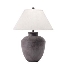 a gray table lamp with a white shade on the base and a light bulb at the end