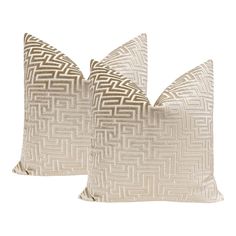 two beige pillows sitting next to each other