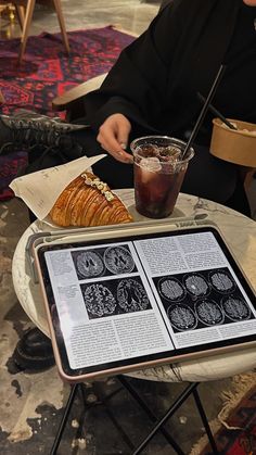 a person sitting at a table with an open book