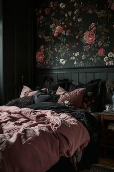 a bedroom with floral wallpaper and black walls