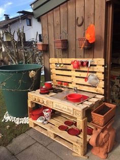 a potting bench made out of pallets and wooden crates with pots on it