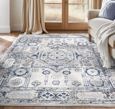 a blue and white rug in front of a window